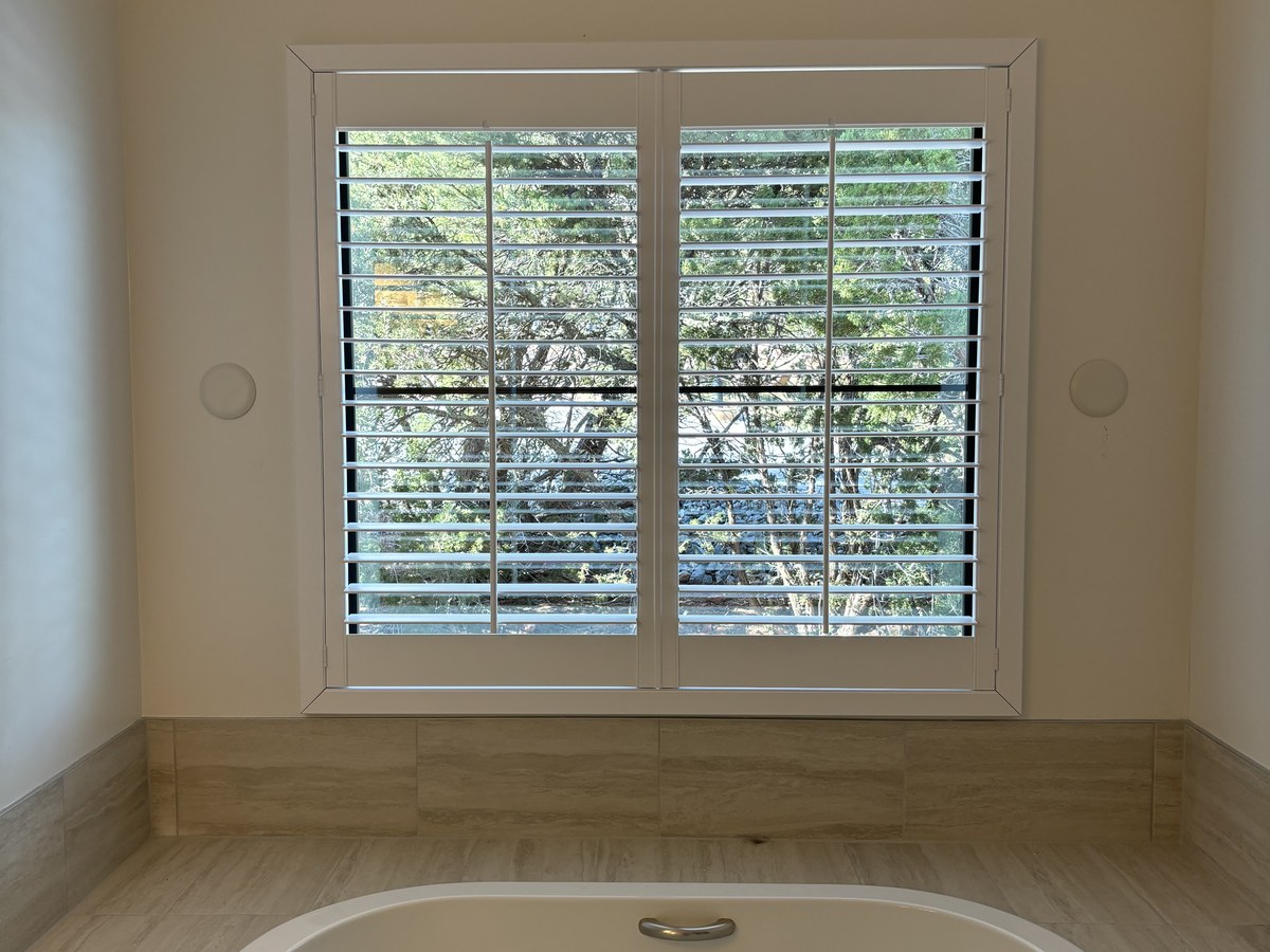 Moisture resistant plantation shutters providing privacy in an Iowa bathroom