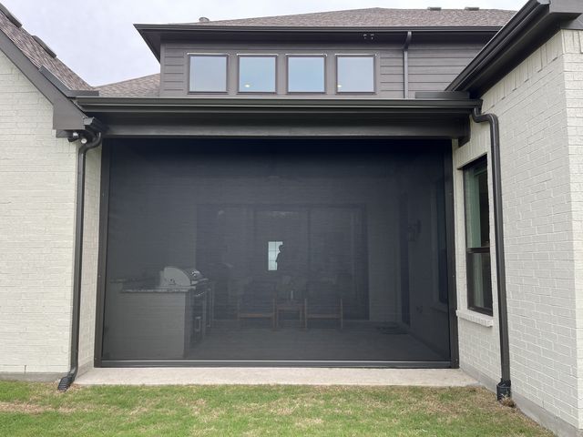 Extended patio solar shades exposed to wind on a Des Moines area patio