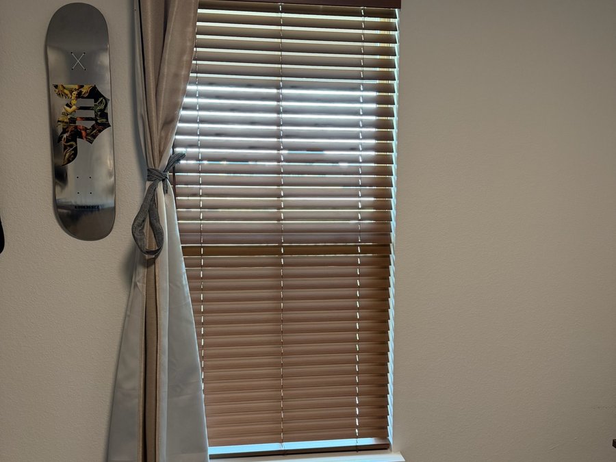 Faux wood blinds in a newer planned development window in the Des Moines metro