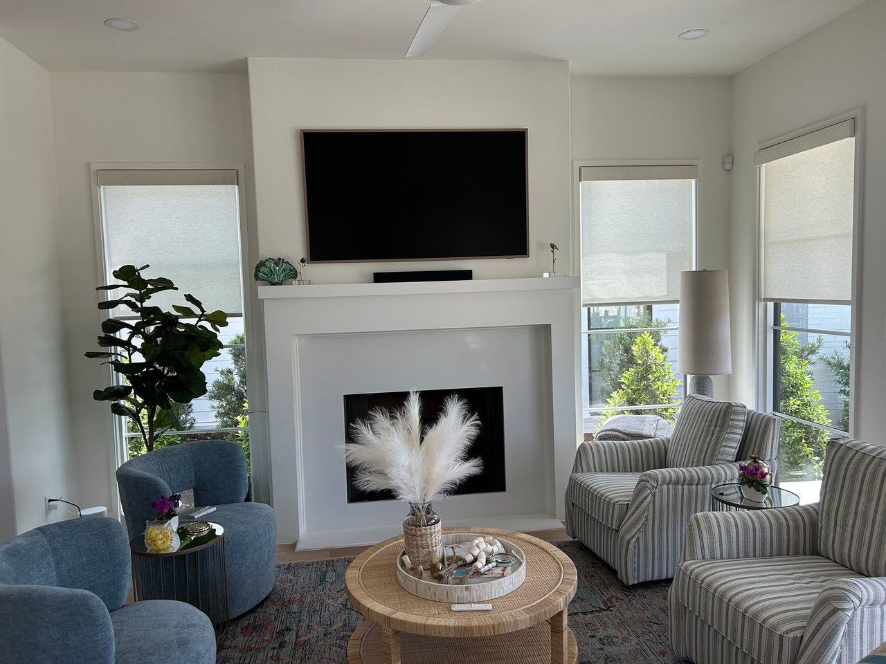 Layered light filtering shades in an open concept new construction living room