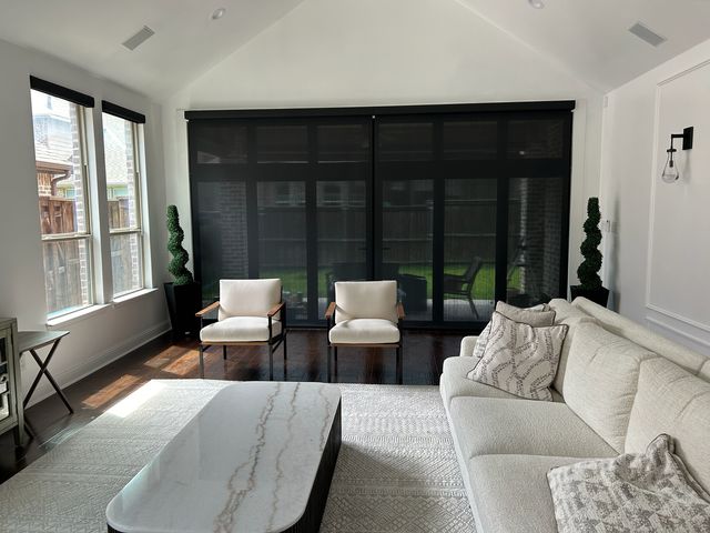 Custom motorized shade replacing basic builder grade blinds in a new home