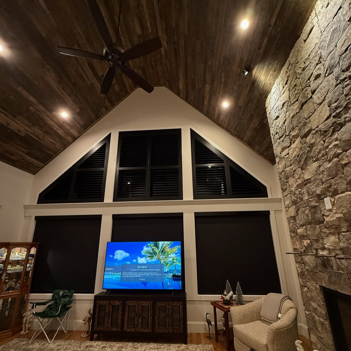 Roller shades fitted to low wide windows typical of a ranch style home