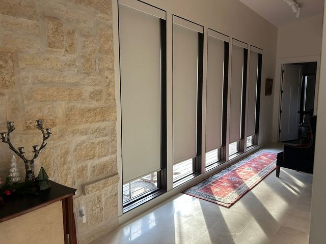 Voice-controlled smart shades responding to an Alexa command in a family living room