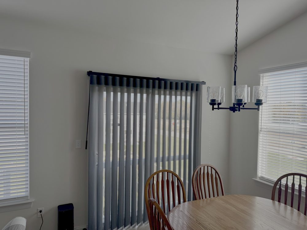 Navy motorized smart drapery on a tall window
