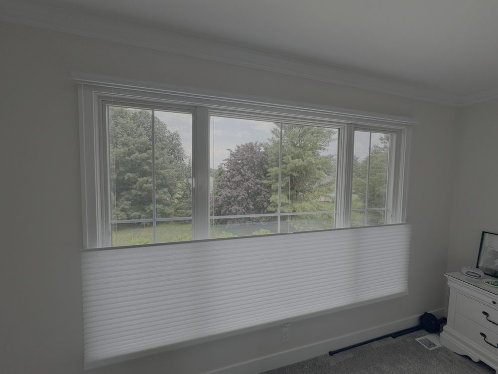 Honeycomb shade in a top-down bottom-up position over a bedroom window