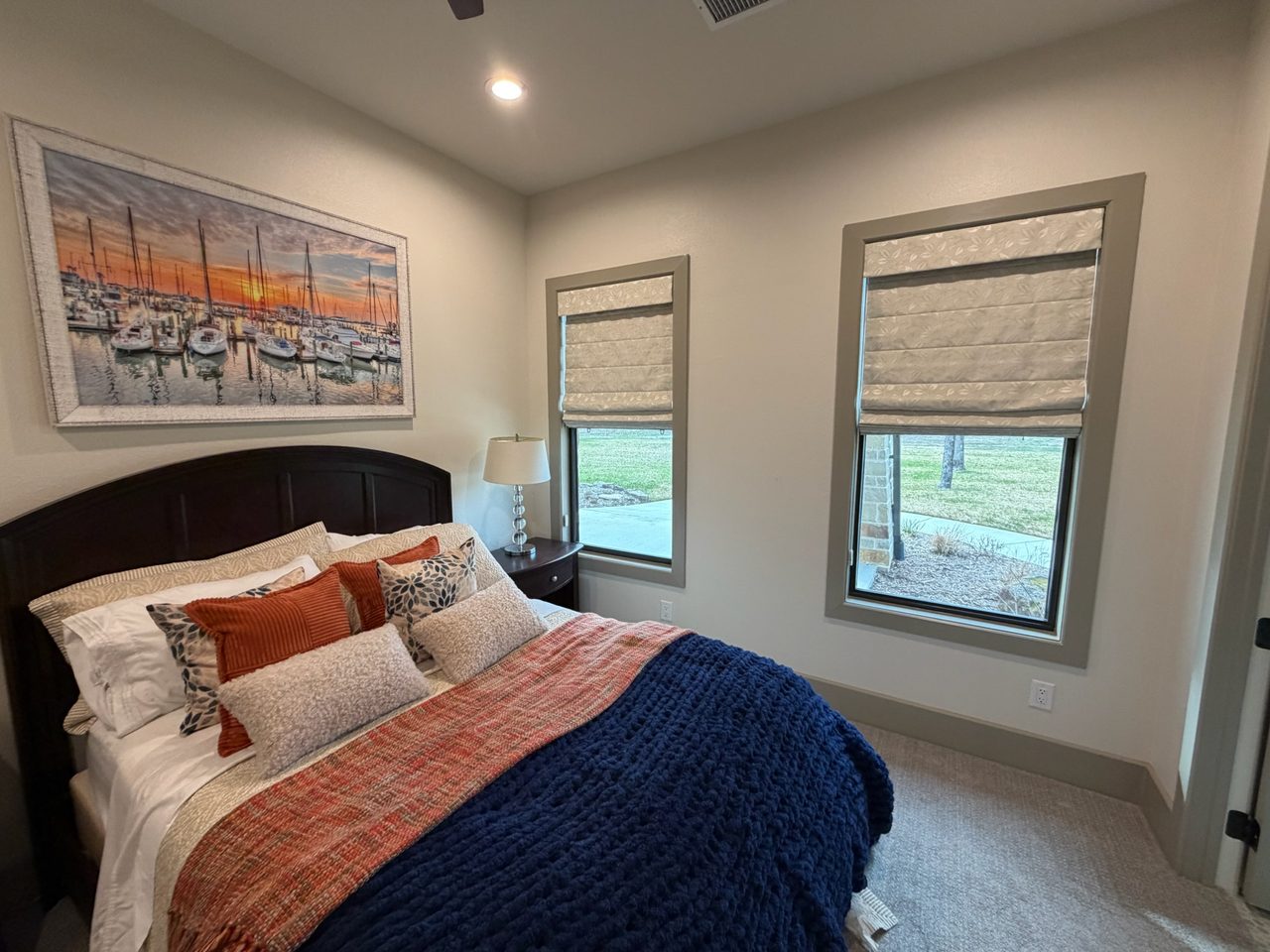 Bright Iowa bedroom with custom Roman shades by Love Is Blinds