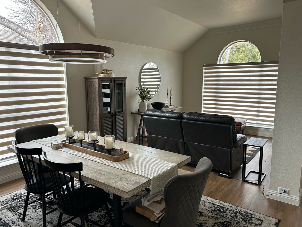 Banded zebra shades in a dining and living room by Love Is Blinds
