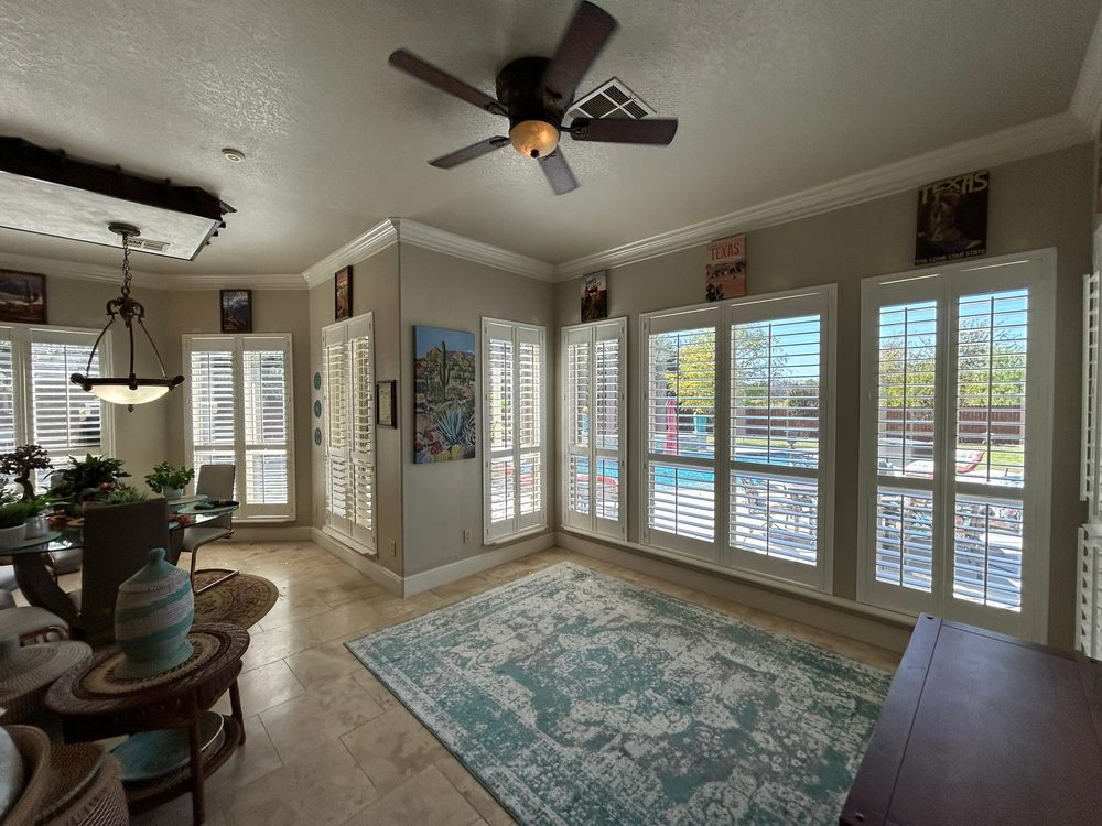 Durable composite plantation shutters in a busy Iowa room by Love Is Blinds